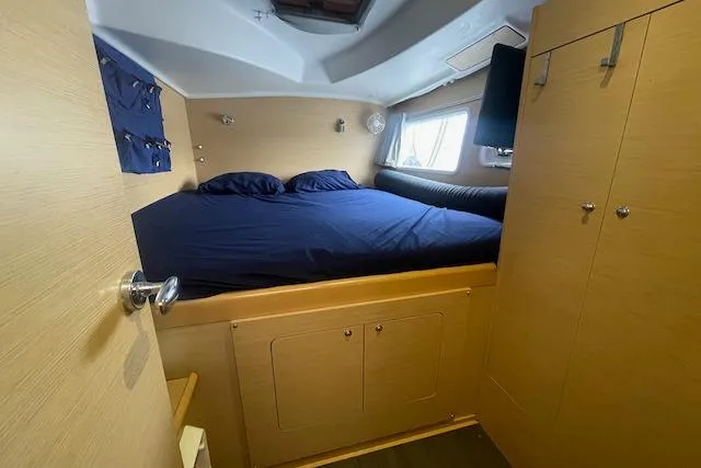 Slide: The Image of 2014 Lagoon 380 S2 interior with TV, radio, and storage cabinets. - 34
