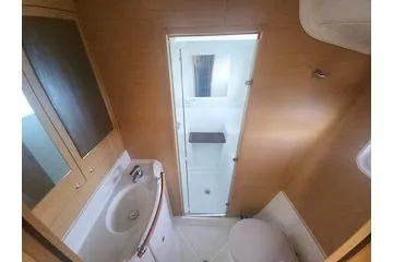 Slide: The Image of 2014 Lagoon 380 S2 yacht bathroom with shower, sink, and toilet. - 46