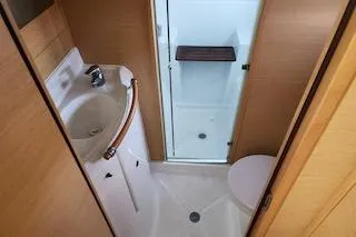 Slide: The Image of 2014 Lagoon 380 S2 yacht bathroom with sink, shower, and toilet. - 47