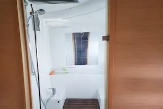 Slide: The Image of Interior view of 2014 Lagoon 380 S2 yacht bathroom with shower and wooden floor. - 49