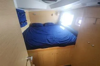 Slide: The Image of Cozy cabin interior of 2014 Lagoon 380 S2 with blue bedding and natural light. - 51