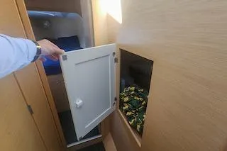 Slide: The Image of Interior of 2014 Lagoon 380 S2 yacht with open storage compartment. - 52