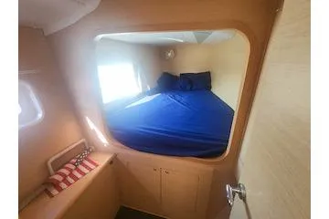 Slide: The Image of 2014 Lagoon 380 S2 cabin interior with bed and window. - 54