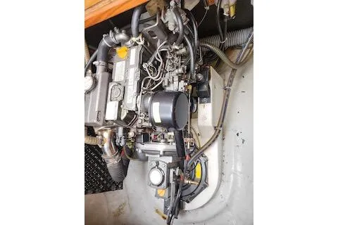 Slide: The Image of Engine compartment of a 2014 Lagoon 380 S2 catamaran, showcasing mechanical components. - 59