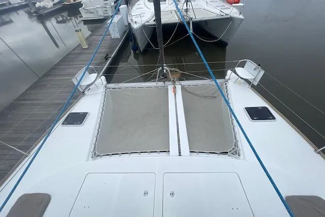 Slide: The Image of 2014 Lagoon 380 S2 catamaran with solar panel on deck, docked at marina. - 8