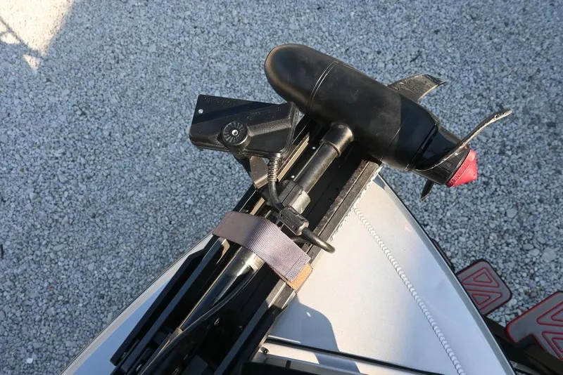 Slide: The Image of 2023 Vexus AVX2080 boat with mounted trolling motor on gravel surface. - 11