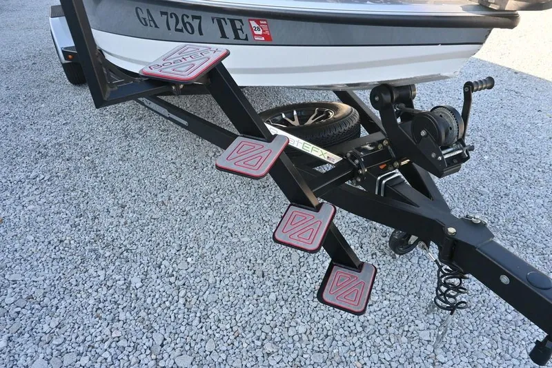 Slide: The Image of 2023 Vexus AVX2080 boat trailer with steps on gravel surface. - 12