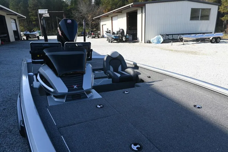 Slide: The Image of 2023 Vexus AVX2080 boat with spacious deck and modern design in a yard setting. - 13