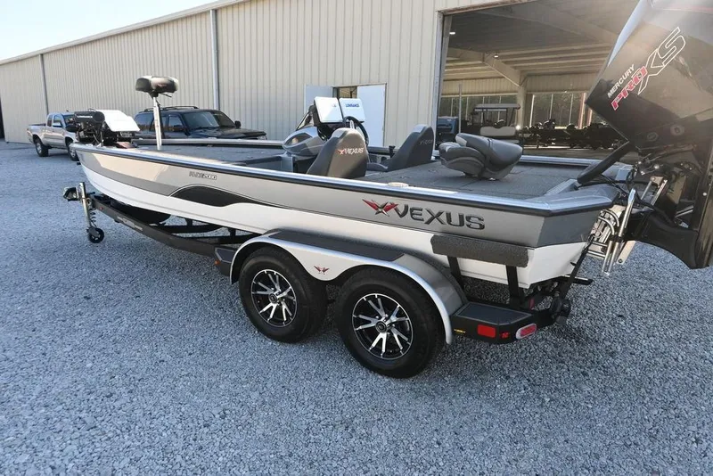 Slide: The Image of 2023 Vexus AVX2080 boat on trailer, parked outside a large building. - 3