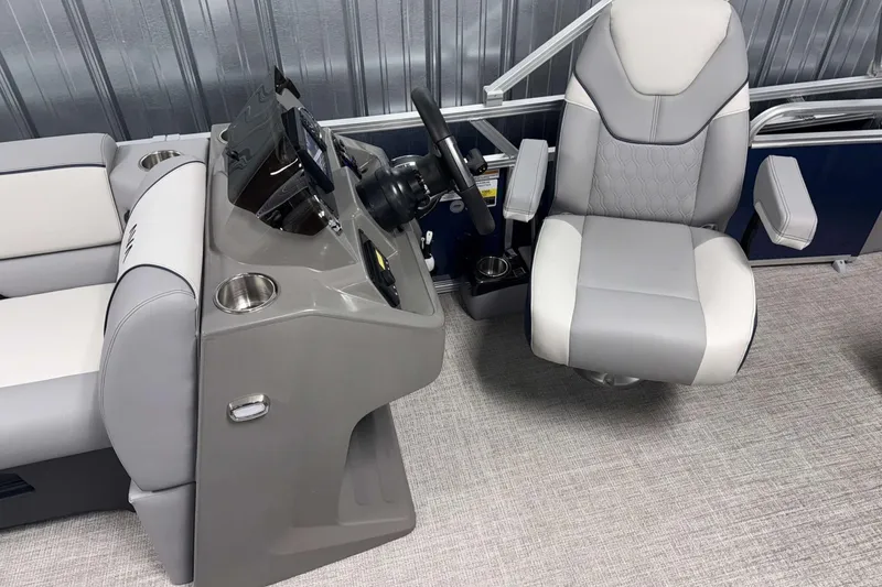 Slide: The Image of 2026 Avalon Venture 2185 VRB boat interior with steering console and captain's chair. - 14