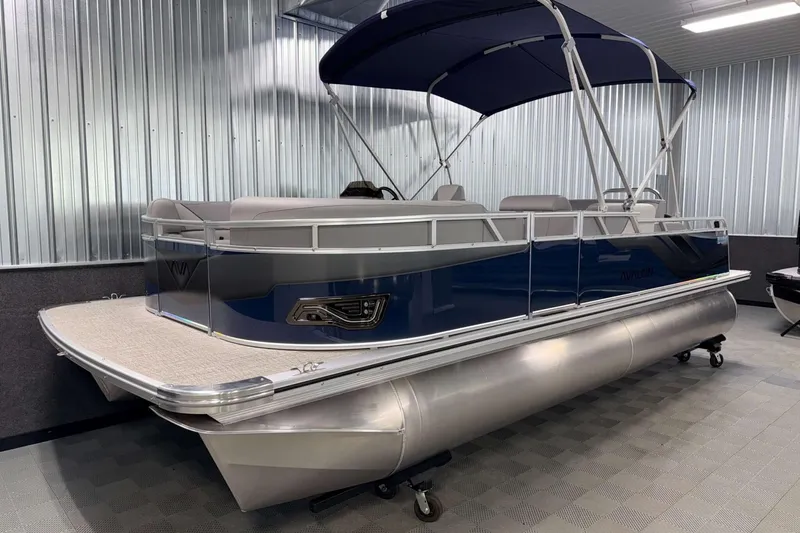 Slide: The Image of 2026 Avalon Venture 2185 VRB pontoon boat in showroom with blue canopy. - 3