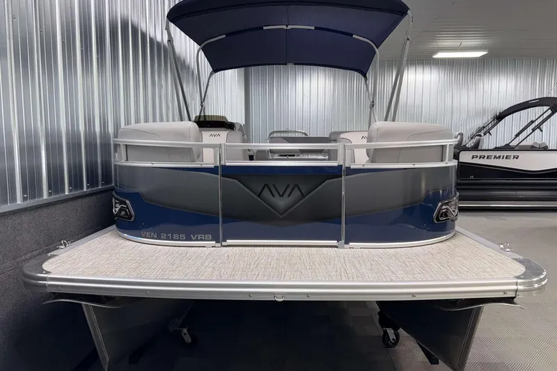 Slide: The Image of 2026 Avalon Venture 2185 VRB pontoon boat in showroom, featuring sleek design and canopy. - 4