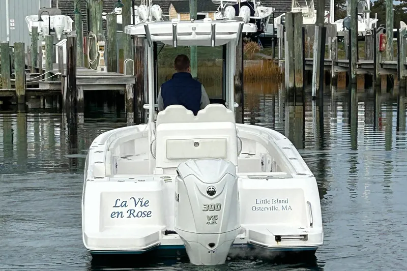 Slide: The Image of 2023 Everglades 235 Center Console boat docked at marina, rear view. - 5