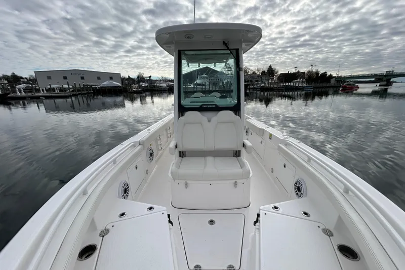 Slide: The Image of 2023 Everglades 235 Center Console boat on calm water under cloudy sky. - 6
