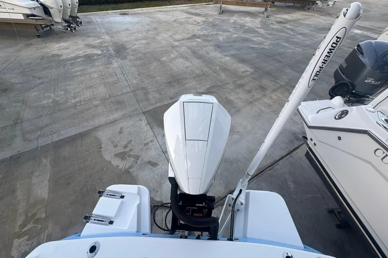 Slide: The Image of 2026 Blackfin 242 HB boat with Mercury outboard engine on calm water. - 11