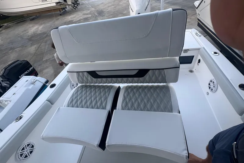 Slide: The Image of 2026 Blackfin 242 HB boat with Mercury Verado engine, open storage compartment. - 14
