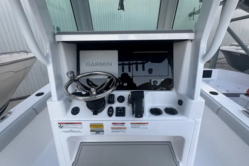 Slide: The Image of 2026 Blackfin 242 HB boat interior with cushioned seating on calm water. - 19
