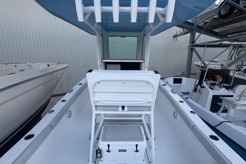 Slide: The Image of 2026 Blackfin 242 HB boat with open hatch and ruler, on calm water. - 20