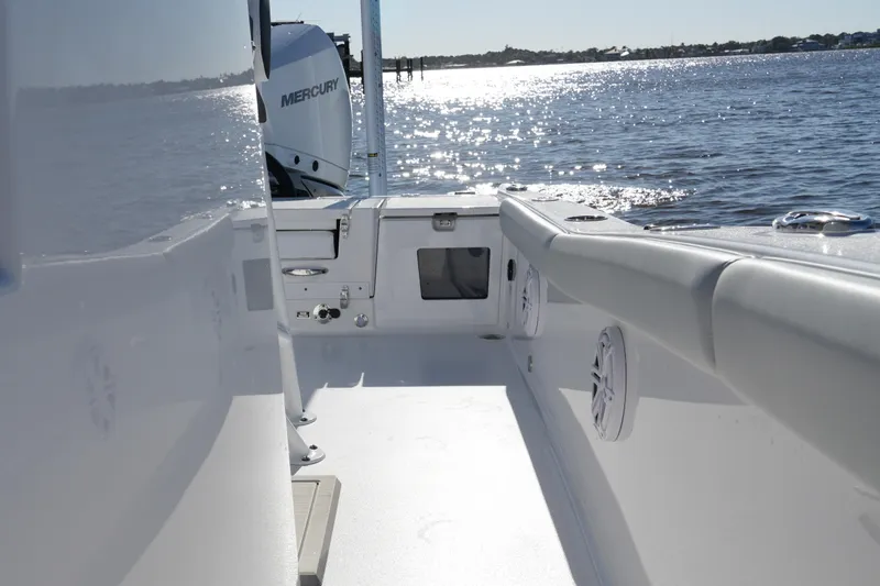 Slide: The Image of 2026 Blackfin 242 HB boat interior with Mercury engine on a sunny day. - 28