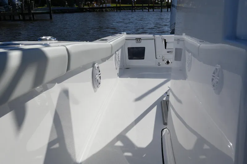 Slide: The Image of 2026 Blackfin 242 HB boat interior, featuring sleek white design and waterfront view. - 29