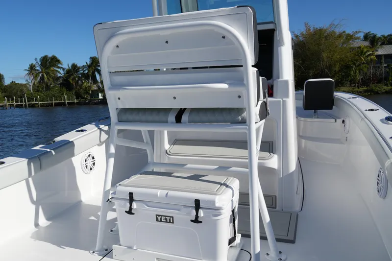 Slide: The Image of 2026 Blackfin 242 HB boat interior with seating and Yeti cooler on a sunny day. - 38