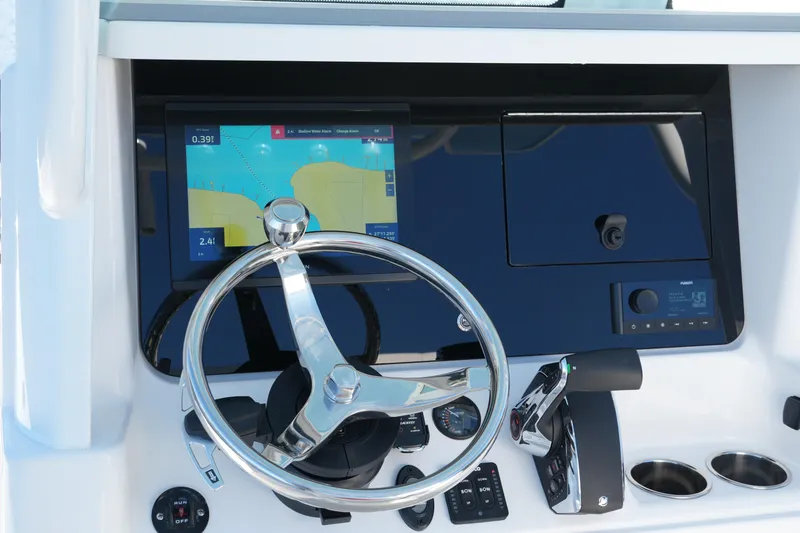 Slide: The Image of 2026 Blackfin 242 HB boat dashboard with steering wheel and navigation display. - 39