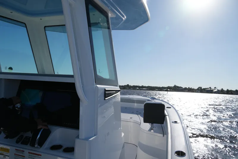 Slide: The Image of 2026 Blackfin 242 HB boat cruising on sunny waters. - 45