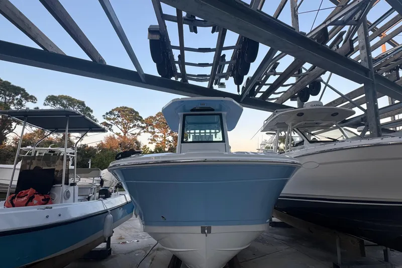 Slide: The Image of 2026 Blackfin 242 HB boat cruising on calm water, aerial view. - 9