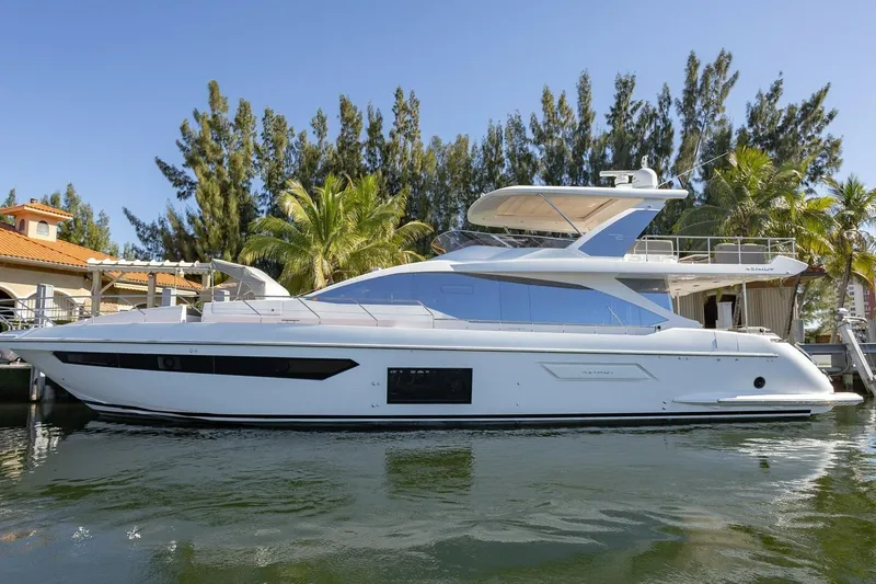 The Image of 2021 Azimut Fly 72 yacht docked by palm trees, showcasing sleek design and luxury features. - 0