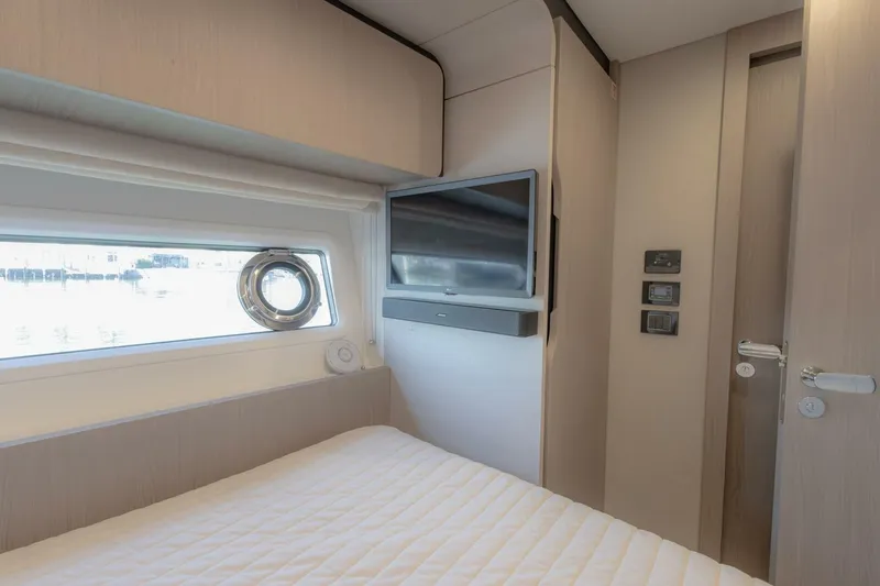 Slide: The Image of Interior of 2021 Azimut Fly 72 yacht bedroom with window and TV. - 42