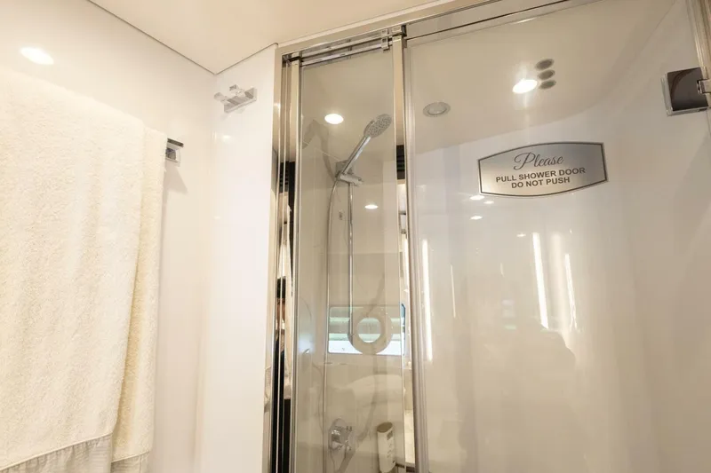 Slide: The Image of Luxurious bathroom shower in 2021 Azimut Fly 72 yacht with glass door and towel. - 44