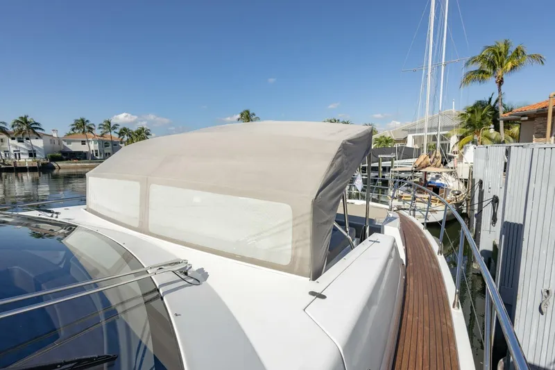 Slide: The Image of 2021 Azimut Fly 72 yacht docked, featuring sleek design and covered flybridge. - 63