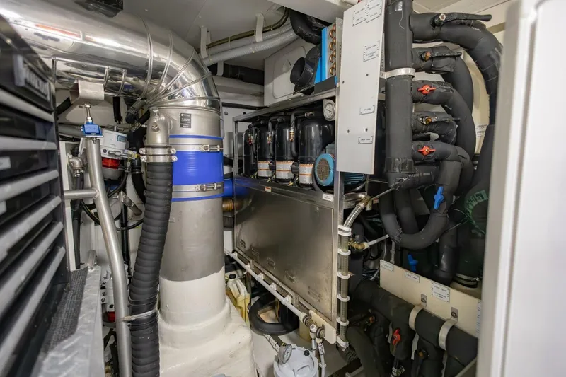 Slide: The Image of Engine room of 2021 Azimut Fly 72 yacht, showcasing complex mechanical systems and piping. - 74