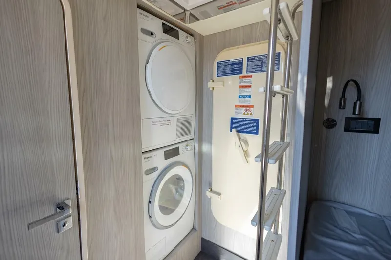Slide: The Image of Laundry area with stacked washer and dryer on Azimut Fly 72 yacht, 2021 model. - 75