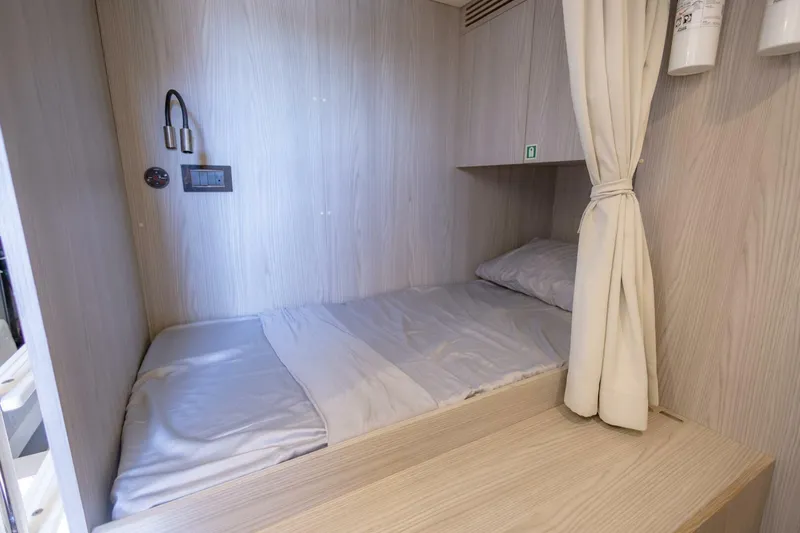 Slide: The Image of Cozy cabin bed in 2021 Azimut Fly 72 yacht, featuring light wood paneling. - 78