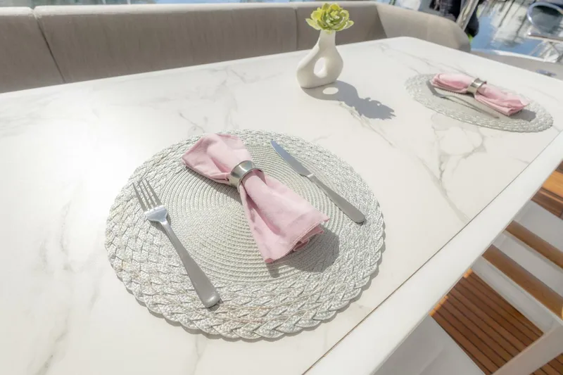 Slide: The Image of Elegant dining setup on 2021 Azimut Fly 72 yacht with pink napkins and silverware. - 9