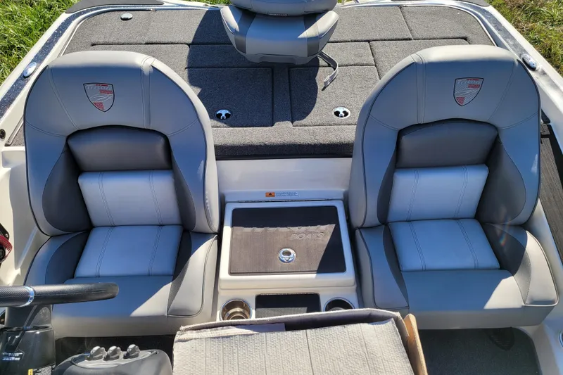 Slide: The Image of 2024 Triton 18 TrX boat interior with dual gray seats and console. - 11