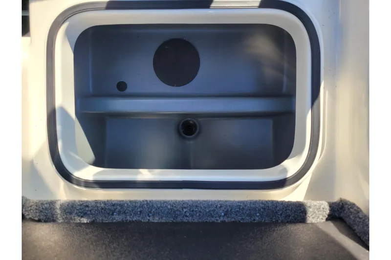 Slide: The Image of 2024 Triton 18 TrX livewell interior, featuring a clean, spacious design. - 15