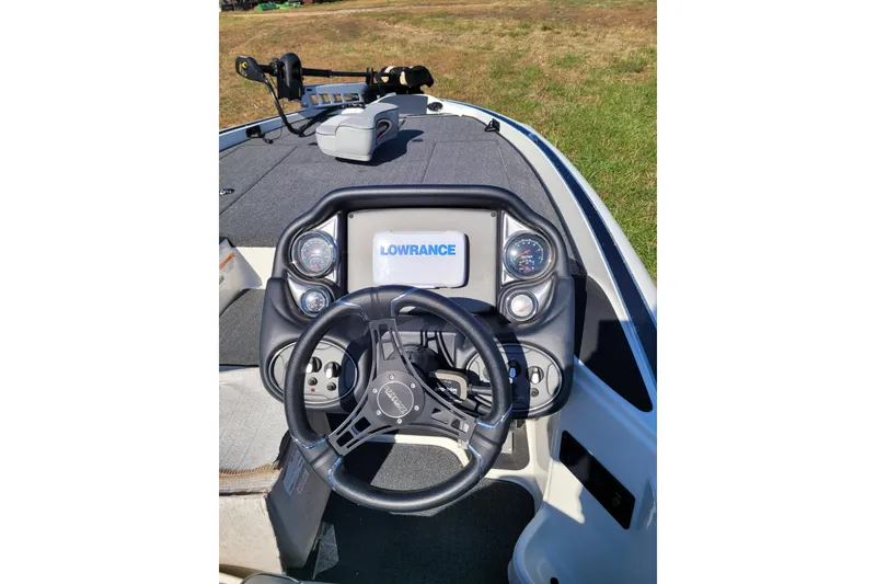 Slide: The Image of 2024 Triton 18 TrX boat dashboard with Lowrance display and steering wheel. - 4