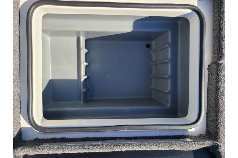 Slide: The Image of 2024 Triton 18 TrX boat storage compartment, open and empty. - 5