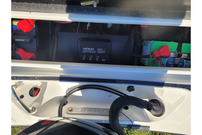 Slide: The Image of 2024 Triton 18 TrX boat battery compartment with NOCO Genius GENPRO 10X3 charger. - 7