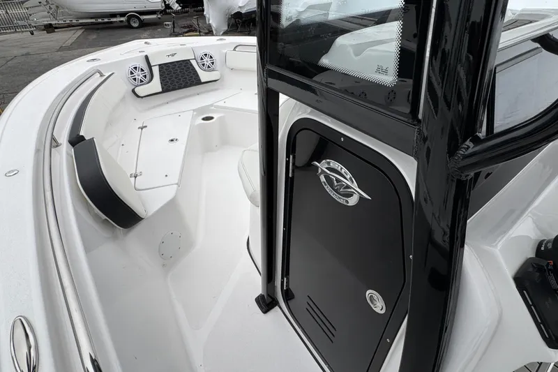 Slide: The Image of 2026 Tidewater 210 CC Adventure boat interior with seating and storage compartment. - 13