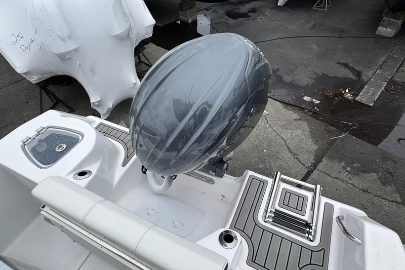 Slide: The Image of 2026 Tidewater 210 CC Adventure boat with covered outboard motor and deck view. - 14