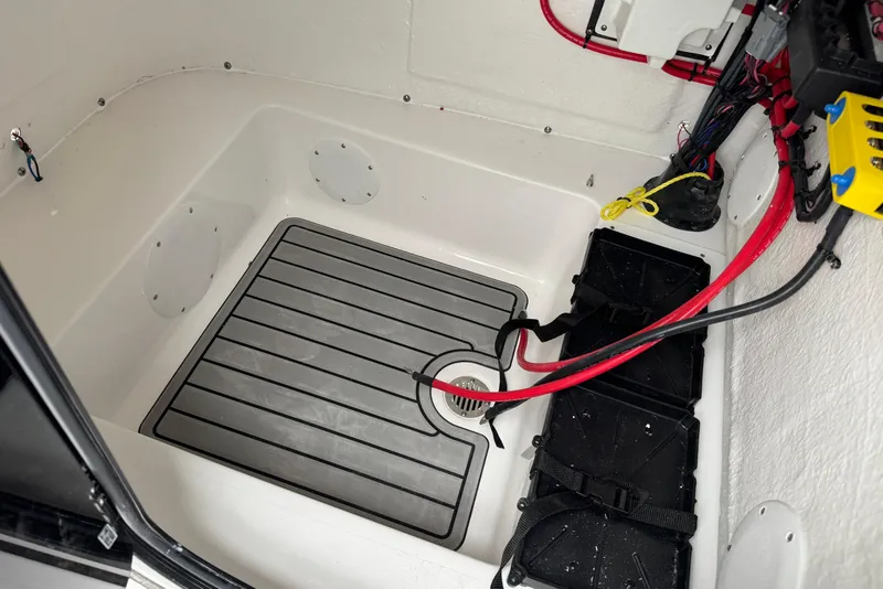 Slide: The Image of Interior view of 2026 Tidewater 210 CC Adventure boat's storage compartment with wiring. - 15