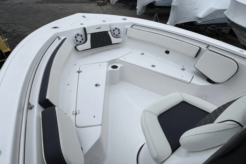 Slide: The Image of 2026 Tidewater 210 CC Adventure boat interior with white seating and speakers. - 17