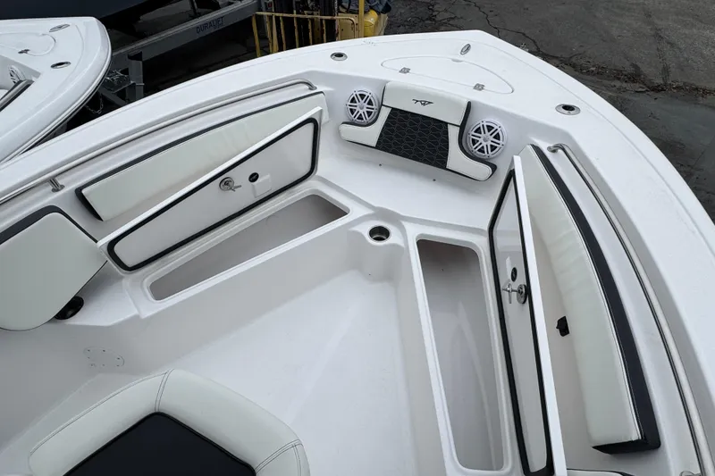 Slide: The Image of 2026 Tidewater 210 CC Adventure boat interior with storage compartments and speakers. - 19