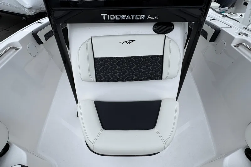 Slide: The Image of 2026 Tidewater 210 CC Adventure boat seating with black and white upholstery. - 22