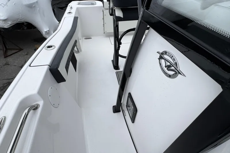 Slide: The Image of 2026 Tidewater 210 CC Adventure boat interior with seating and console details. - 24