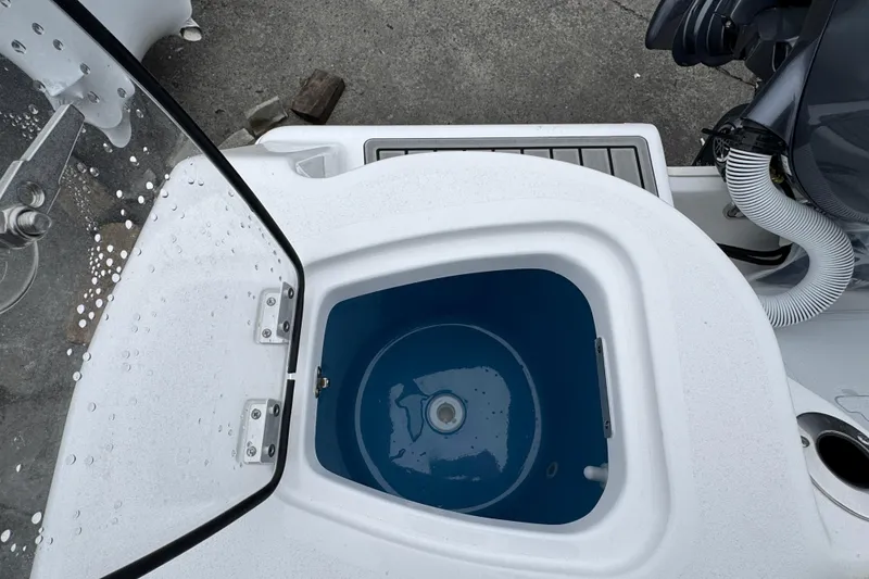 Slide: The Image of Livewell on 2026 Tidewater 210 CC Adventure boat, open lid view. - 4