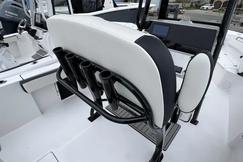 Slide: The Image of 2026 Tidewater 210 CC Adventure boat interior with rod holders and Yamaha engine. - 5